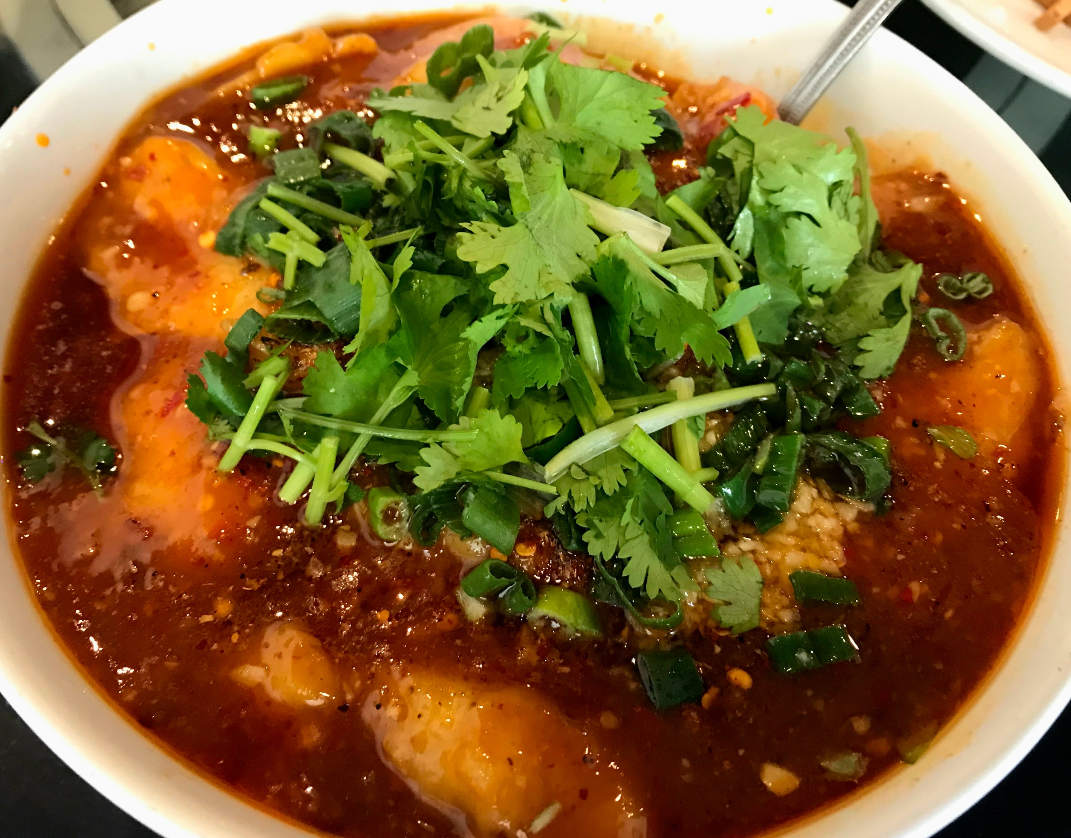 Sichuan-style hot sauce fish dish topped with fresh cilantro